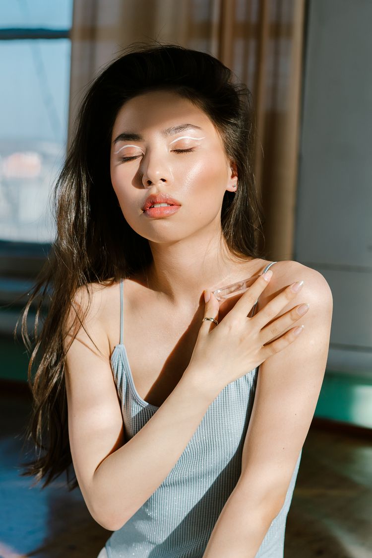 Woman closing her eyes with contentedness and feeling at peace. 