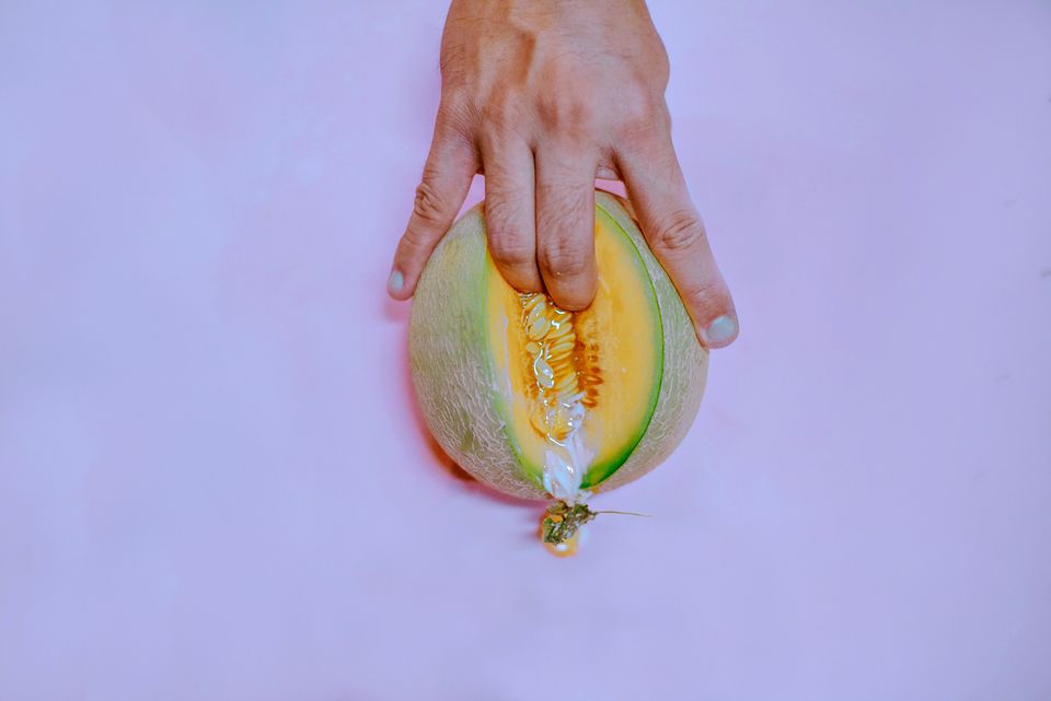 Fingering a melon with sexual suggestion